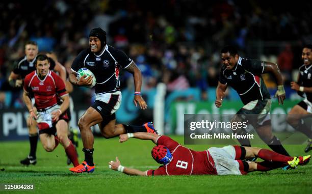Centre Andrew Suniula of USA burts through the tackle from Artem Fatakhov of Russia during the IRB 2011 Rugby World Cup Pool C match between Russia...