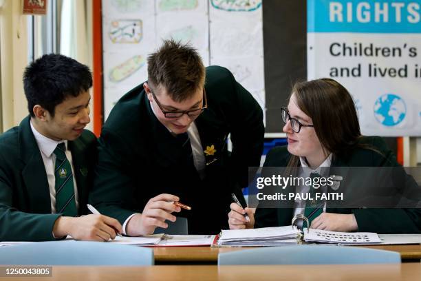 Pupils Derek Tsang, Charlie Durham-Crummey and Anna McKittrick study in a classroon at Priory Integrated college in Holywood, on March 15, 2023. -...