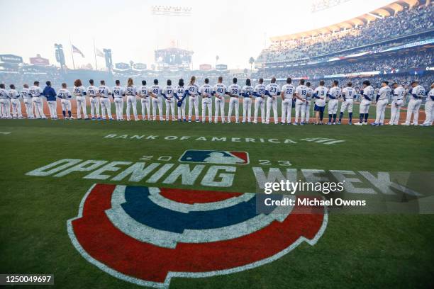 Members of the Los Angeles Dodgers stand on the field prior to the game between the Arizona Diamondbacks and the Los Angeles Dodgers at Dodger...