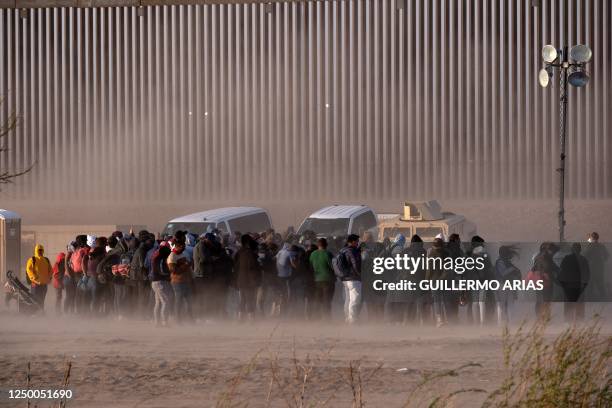 Migrants wait to be processed by United States Border Patrol seen from Ciudad Juarez, Chihuahua state, Mexico, on March 30, 2023. - Five people have...