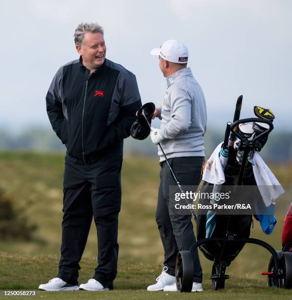 Great Britain and Ireland captain Stuart Wilson speaks with John Gough during a Walker Cup Squad Practice Session at St Andrews Old Course on March...