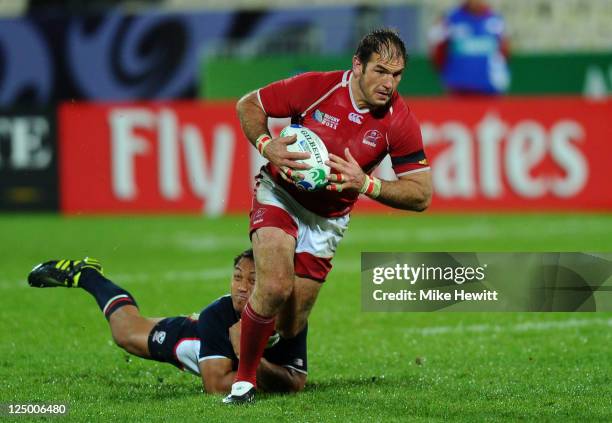 Vyacheslav Grachev of Russia is tackled by Roland Suniula of USA during the IRB 2011 Rugby World Cup Pool C match between Russia and the USA at...