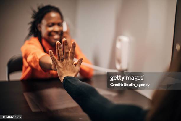 woman visit her girlfriend in prison - people say hello stock pictures, royalty-free photos & images