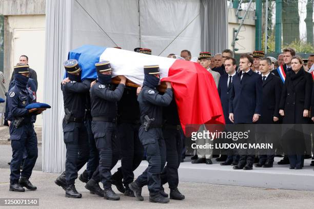 Gendarmes carry the coffin past French National Assembly president Yael Braun-Pivet , French Interior Minister Gerald Darmanin , French President...