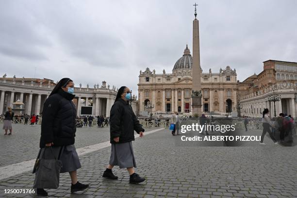 Nuns walk across St. Peter's square in The Vatican on March 31 two days after the Pope was admitted to the Gemelli hospital in Rome. - Pope Francis...