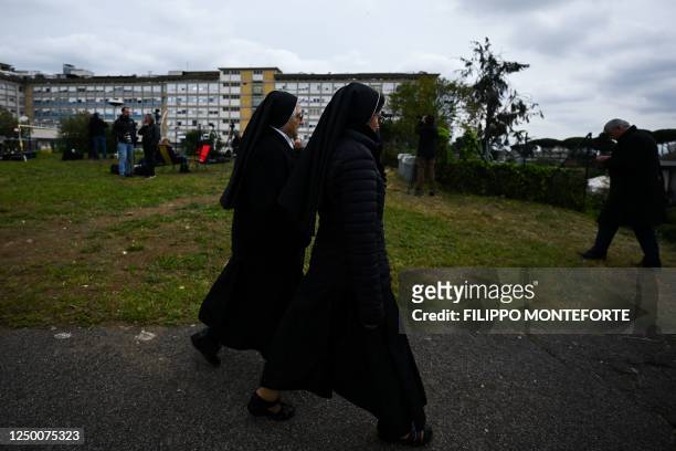 Nuns walk past the Gemelli hospital on March 31, 2023 in Rome, two days after the Pope was admitted to the Gemelli hospital in Rome. - Pope Francis...