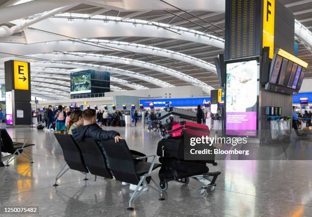 Passengers wait at the check-in area during a strike by security workers at London Heathrow Airport in London, UK, on Friday, March 31, 2023. IAG...