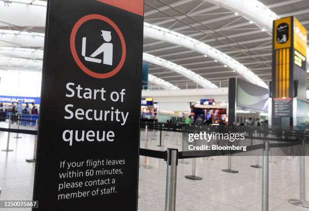 Sign indicating the start of the security queue during a strike by security workers at London Heathrow Airport in London, UK, on Friday, March 31,...