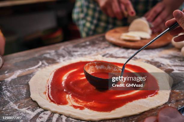 kids baking with their mother pizza at home - pizza ingredients stock pictures, royalty-free photos & images