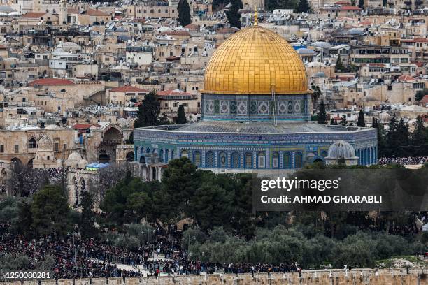 This picture taken from the Mount of Olives on March 31, 2023 shows Palestinian worshippers attending the second Friday prayers during the Muslim...