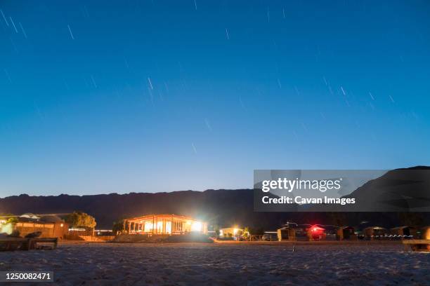 illuminated straw huts at nuweiba by the beach, south sinai at night - nuweiba beach stock pictures, royalty-free photos & images