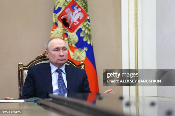 Russian President Vladimir Putin chairs a Security Council meeting via a video link at the Kremlin in Moscow on March 31, 2023.