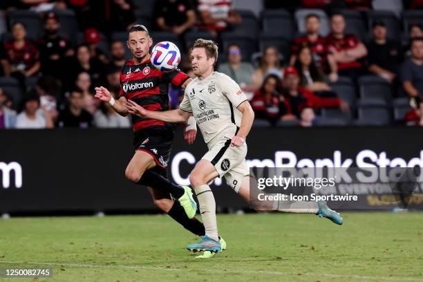 Louis D'Arrigo of Adelaide united and Amor Layouni of Western Sydney Wanderers battle for the ball during the A-League Men's football match between...