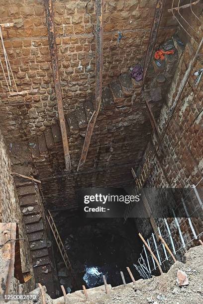 General view shows the stepwell where people fell as the floor area that was covering it collapsed, inside a Hindu temple in Indore on March 31,...