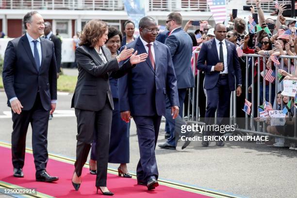 Vice President Kamala Harris and her husband, US Second Gentleman Douglas Emhoff walk with Tanzania's Vice President, Dr Philip Mpango upon their...
