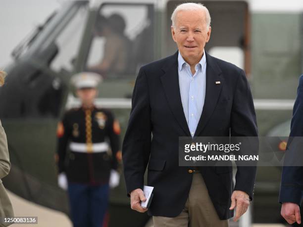 President Joe Biden makes his way to board Air Force One before departing from Joint Base Andrews in Maryland on March 31, 2023. - Biden is heading...