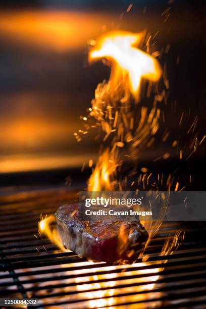 beautiful grilled steak with sparks of fire - grilled steak stock pictures, royalty-free photos & images