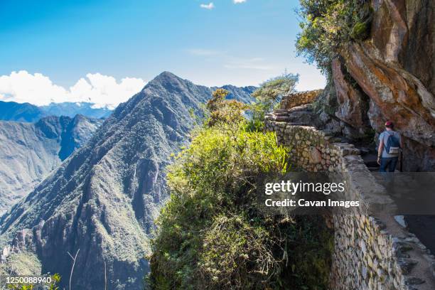 man hiking up the inca trail path close to machu picchu - hiking machu picchu stock pictures, royalty-free photos & images