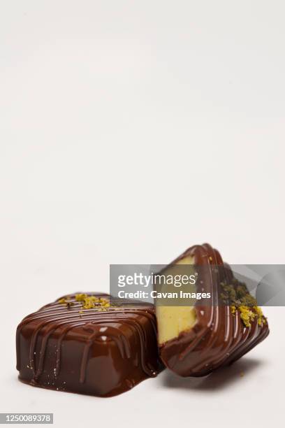 hand made pralines with marzipan filling on white background - marzipan stock-fotos und bilder