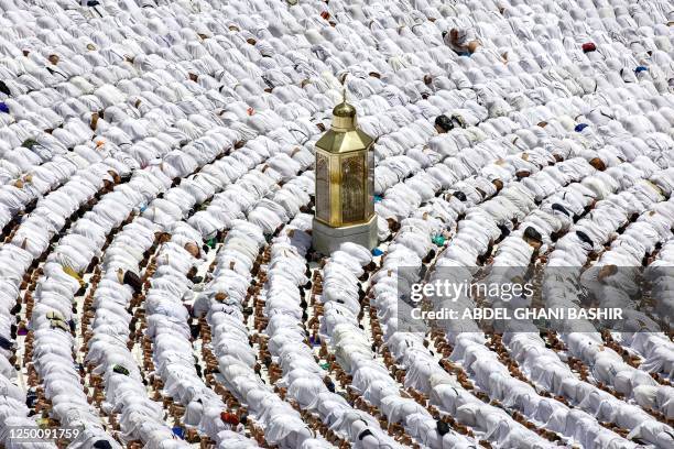 Muslim worshippers stand around Maqam Ibrahim as they pray around the Kaaba , Islam's holiest shrine, at the Grand Mosque in the holy city of Mecca...