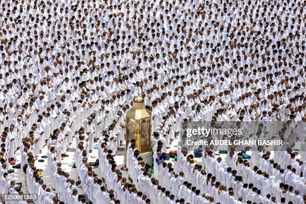 Muslim worshippers stand around Maqam Ibrahim as they pray around the Kaaba , Islam's holiest shrine, at the Grand Mosque in the holy city of Mecca...