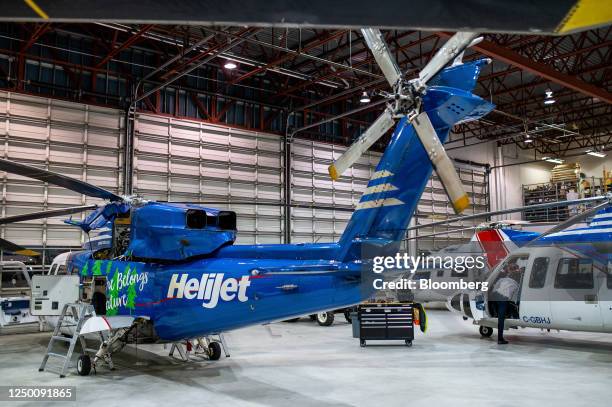 Pilots perform pre-flight checks on a helicopter at the Helijet hanger at Vancouver International Airport in Richmond, British Columbia, Canada, on...