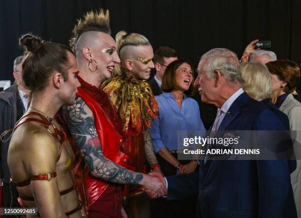 Britain's King Charles III shakes hands with members of the German industrial metal band "Lord of the Lost) at the end of a reception at the Schuppen...