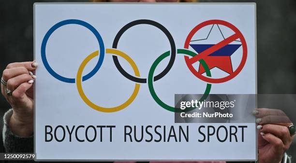 Protester in Krakow holds a powerful poster related to Summer Olympics in Paris and the words 'Boycott Russian Sport,' outside Krakow's Adam...