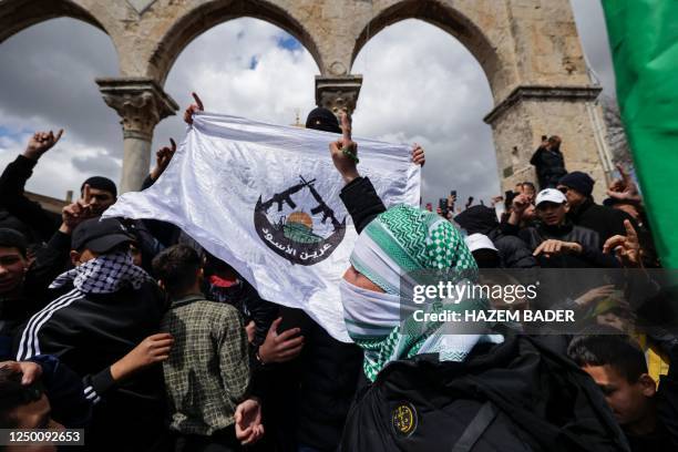 Palestinians chant anti-Israel slogans and lift flags during a demonstration following the second Friday prayer of the Muslim holy fasting month of...