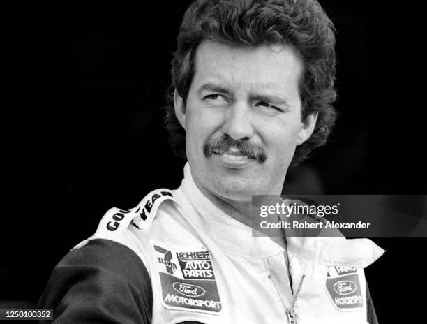 Driver Kyle Petty stands in the speedway garage prior to the start of the 1985 Daytona 500 stock car race at Daytona International Speedway in...