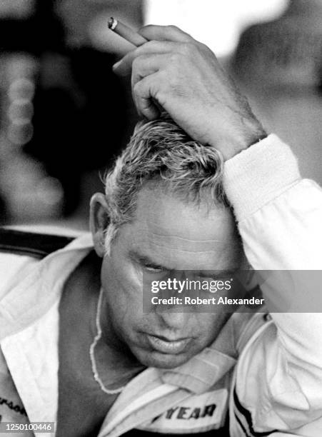 Driver David Pearson relaxes in the speedway garage prior to the start of the 1985 Daytona 500 stock car race at Daytona International Speedway in...