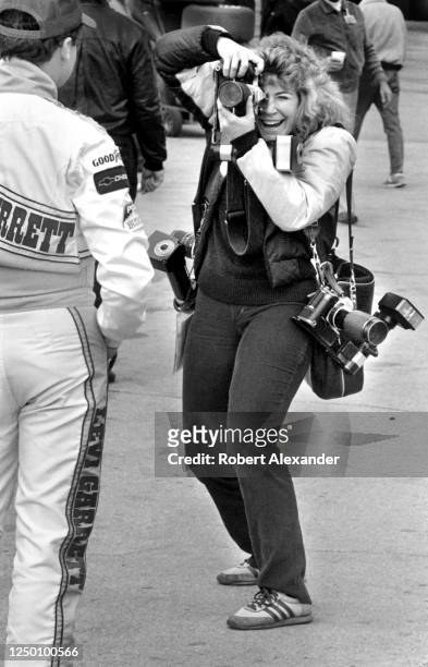 Photographer takes a picture of NASCAR driver Geoff Bodine in the speedway garage area prior to the start of the 1988 Daytona 500 stock car race at...