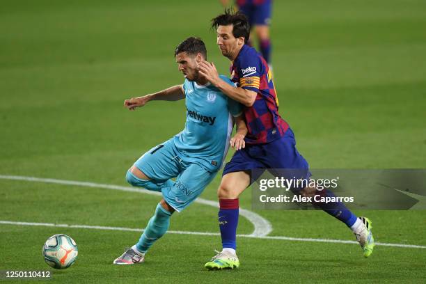 Ruben Perez of Leganes battles for possession with Lionel Messi of Barcelona during the Liga match between FC Barcelona and CD Leganes at Camp Nou on...