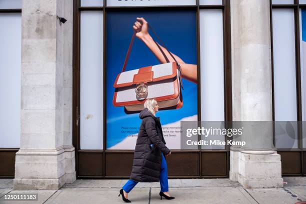 Large scale advertising imagery for the fashion retailer Longchamp on 30th March 2023 in London, United Kingdom. Passing people interact with the...