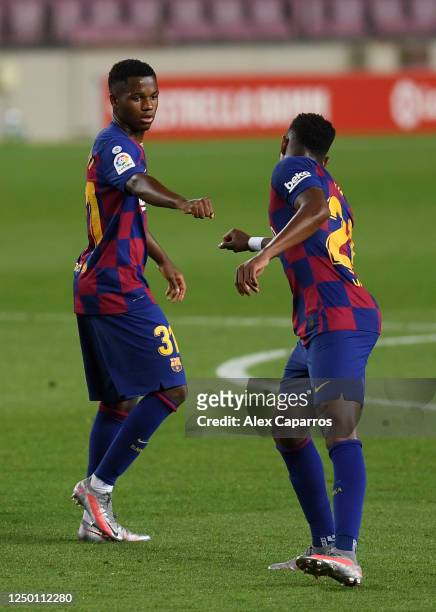 Anssumane Fati of Barcelona celebrates with Junior Firpo of Barcelona after he scores his teams first goal during the Liga match between FC Barcelona...
