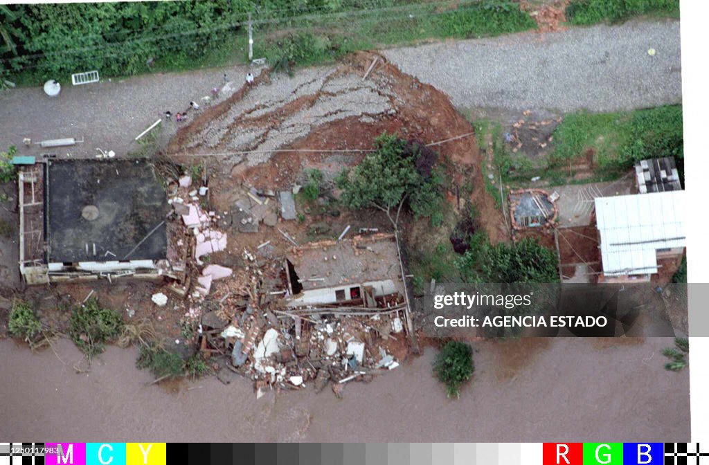 An aerial view shows a road and a house partially destroyed 07... News ...