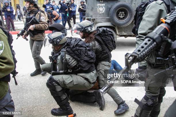 Israeli border guards assault a Palestinian demonstrator during his arrest, during a "Land Day" demonstration in the Palestinian town of Huwara in...