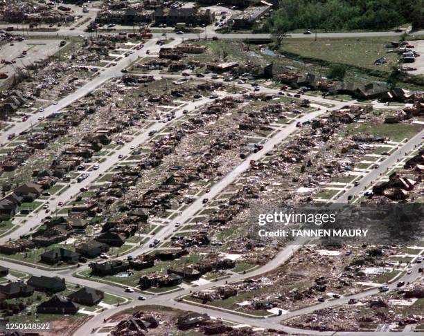 Tornado's path is traced with intact homes on both sides of this neighborhood while others lie destroyed in Moore, Oklahoma, 05 May 1999, two days...