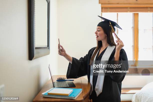 Teenage girl phone chatting wearing cap and gown