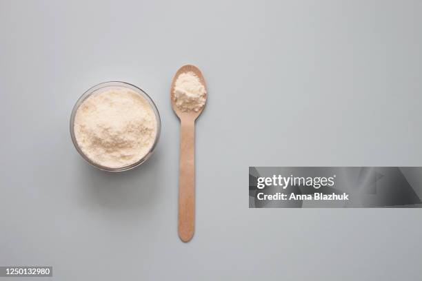 collagen powder over pastel blue background with copy space. dietary nutritional supplement - gerieben stock-fotos und bilder