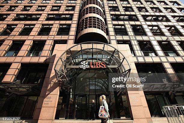 Woman walks past the UK headquarters of the Swiss banking group UBS after it was announced that unauthorised trades by an investment banker had cost...