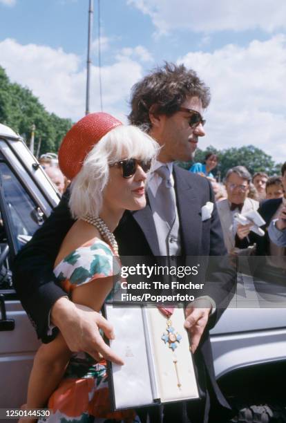 Bob Geldof, singer, songwriter and political activist, with his wife, television presenter and writer Paula Yates , after receiving his Knighthood in...