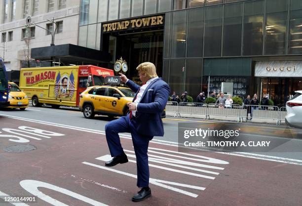 Neil Greenfield, impersonating former US president Donald Trump, performs in front of Trump Tower in New York on March 31 the day after Trump was...