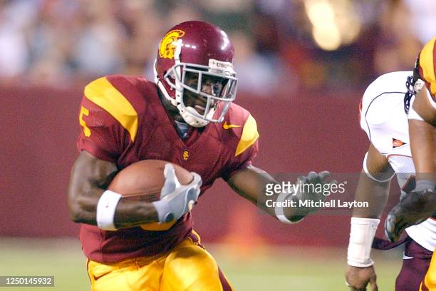 Reggie Bush of the USC Trojans runs with the ball during a college football game against the Virginia Tech Hokies on August 24, 2004 at FedEx Field...