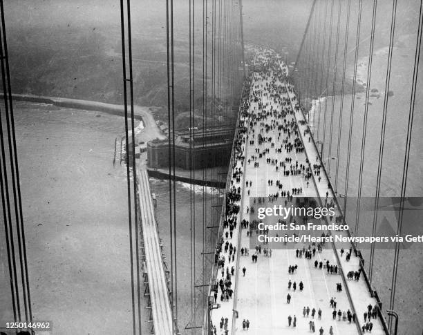 Walkers take advantage of Pedestrians Day, the first of two opening days for the Golden Gate Bridge, May 27, 1937. Fort Point can be seen under the...