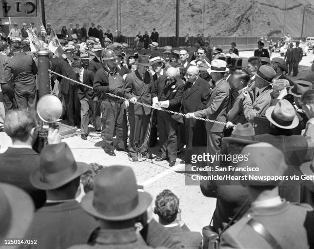Opening day ceremonies at the Golden Gate Bridge include Mayor Angelo Joseph Rossi using a torch to cut through a chain, May 28, 1937.