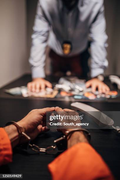 inmate with handcuffs talking with detective in prison visit room - probation stock pictures, royalty-free photos & images