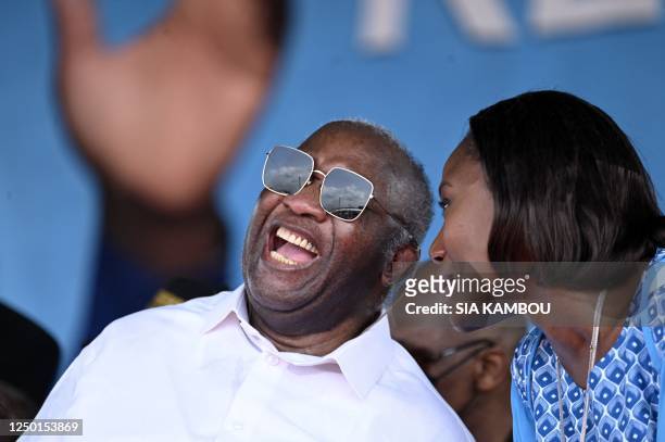 Former Ivorian president Laurent Gbagbo, president of the Parti des Peuples Africains Cote d'Ivoire speaks with his wife Nady Bamba during a party...