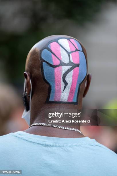 Person with a fist and transgender flag painted on the back of their head is seen at a Black Lives Matter Protest near the Stonewall Inn on June 16,...