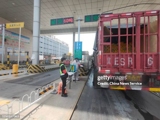 Staff member sprays disinfectant liquid on a truck at the entrance of Hebei Xinfadi agriculture products wholesale market, which belongs to Beijing...